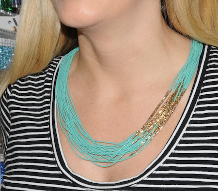 Joan modeling turquoise and gold necklace